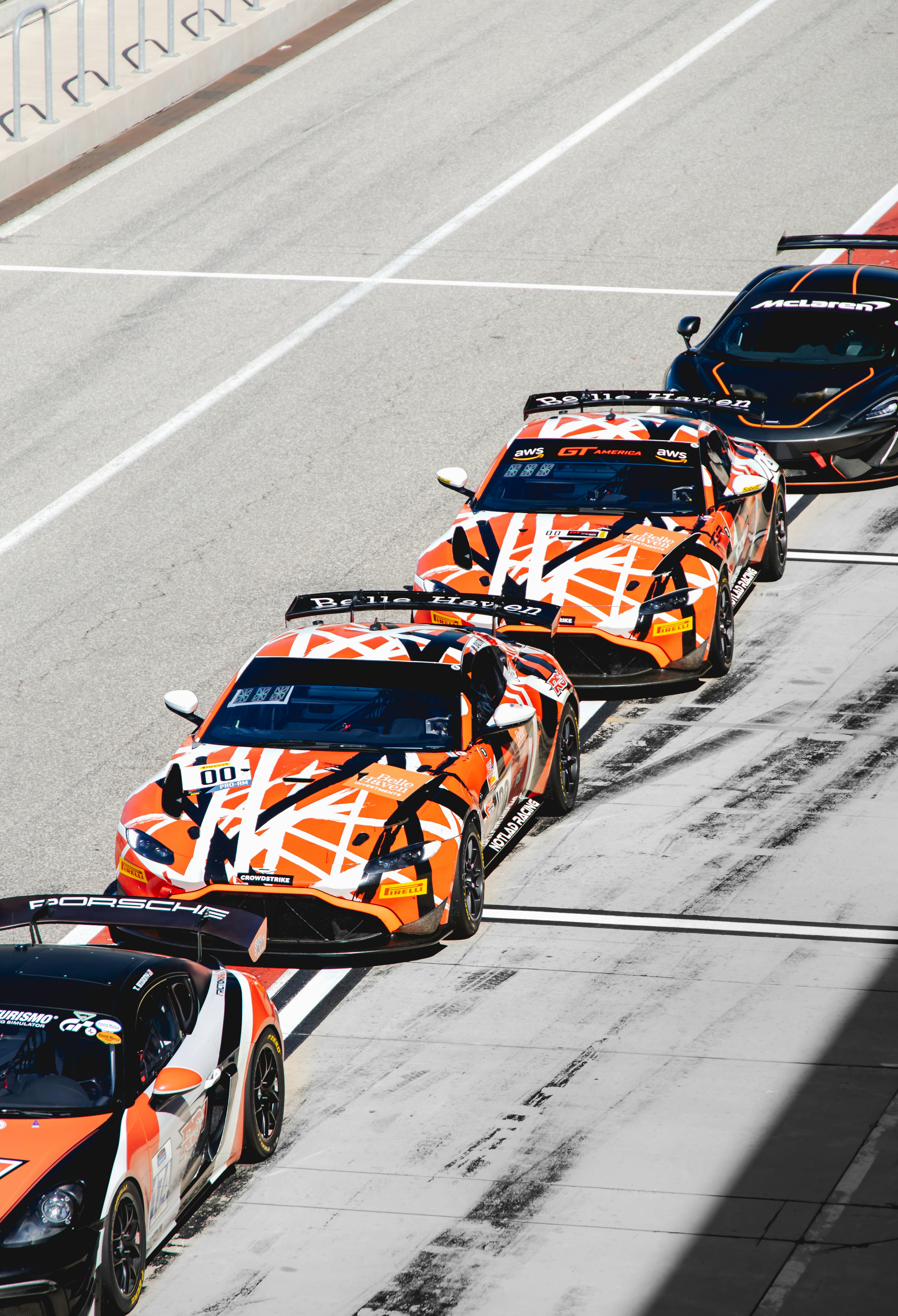 orange and black sports car on road during daytime